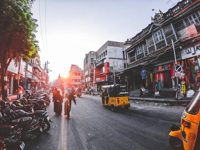 A busy street scene in Coimbatore at sunset